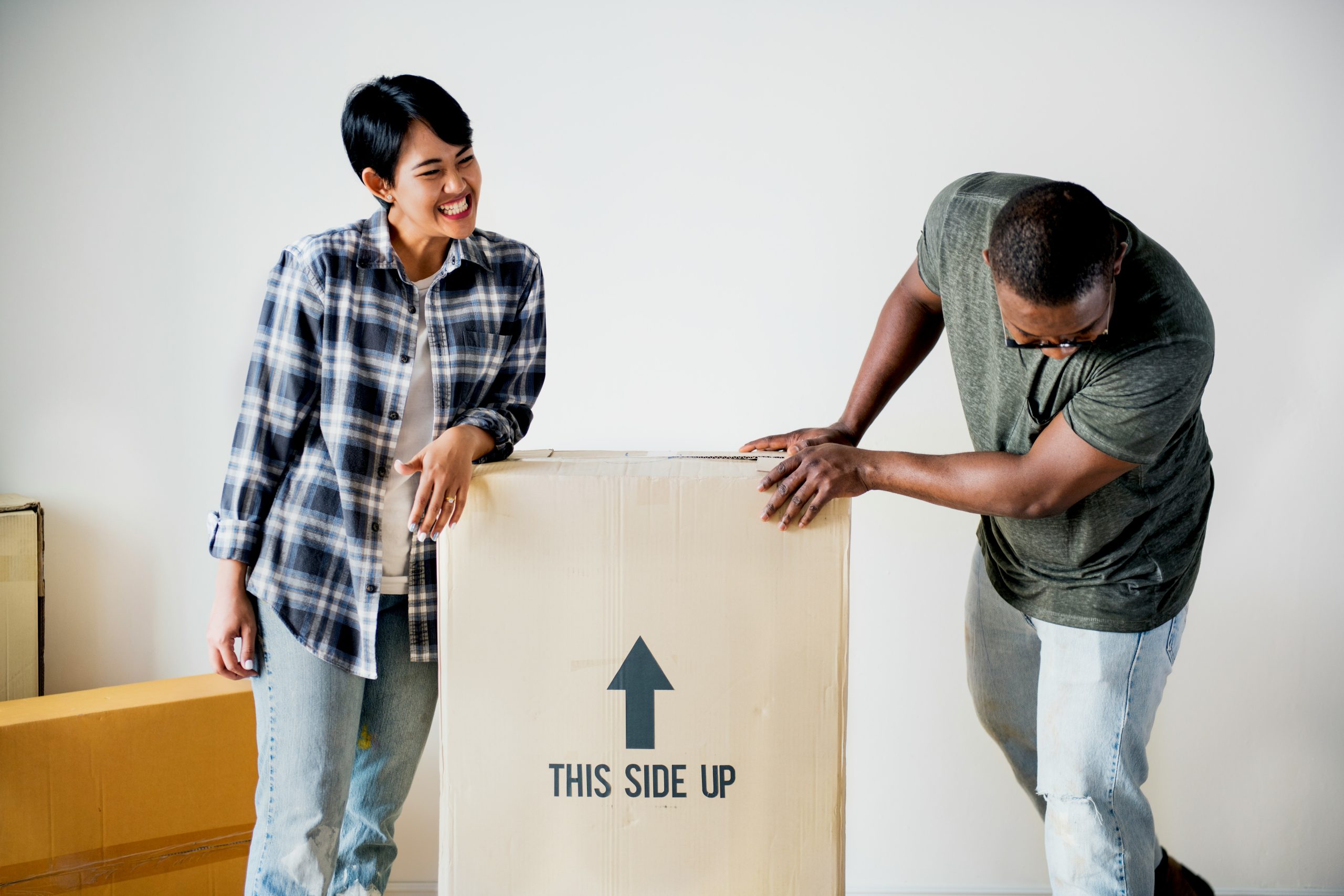 A couple working out how to pack boxes for a house move